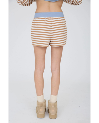 Women’s camel and cream horizontal striped knit lounge shorts with a light blue ribbed waistband, cream drawstring, and side pockets.