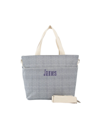 Stripes Cooler Tote in navy stripe featuring an insulated interior, front slip pocket, shoulder straps, removable crossbody strap, and spacious cooler compartment.