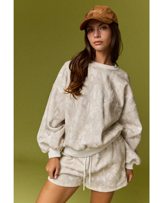 The Aspen Lounge Set featuring a soft neutral tie-dye oversized crewneck sweatshirt with matching relaxed drawstring shorts in a cozy two-piece set.