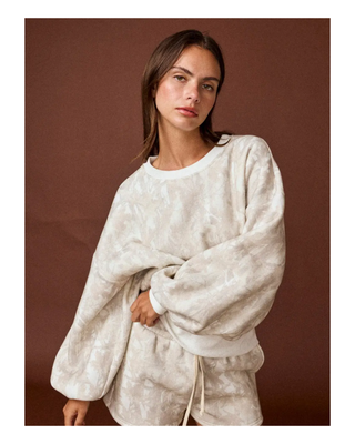 The Aspen Lounge Set featuring a soft neutral tie-dye oversized crewneck sweatshirt with matching relaxed drawstring shorts in a cozy two-piece set.