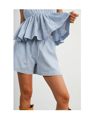 The Bluebell Gingham Shorts featuring a soft blue gingham print, elastic drawstring waistband, relaxed fit, and lightweight woven fabric.