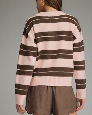 Women's blush pink and mocha brown striped knit sweater featuring a collared button neckline, relaxed fit, and rugby-inspired design.