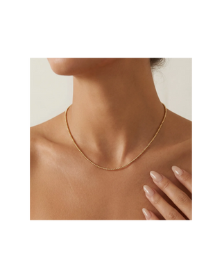Dainty gold beaded necklace featuring small polished round beads in a simple, classic design for women.