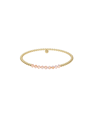 Gold beaded stretch bracelet with blush pink faceted crystal accents for women.
