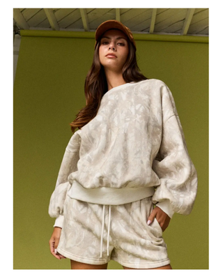 The Aspen Lounge Set featuring a soft neutral tie-dye oversized crewneck sweatshirt with matching relaxed drawstring shorts in a cozy two-piece set.