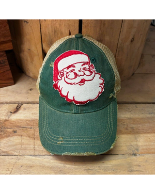 Forest green distressed trucker hat featuring a vintage Santa Claus patch, curved brim, and mesh back.