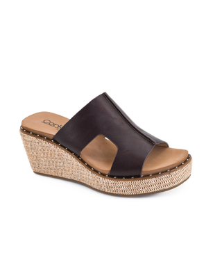 Volta II platform wedge sandal with a black faux leather upper, woven raffia wedge, and cushioned slip-on design.