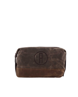 Waxed Dopp Kit in Olive featuring durable waxed canvas, reinforced contrasting base, zip-top closure, and side carry handle.