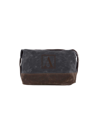 Waxed Dopp Kit in Slate featuring durable waxed canvas, reinforced contrasting base, zip-top closure, and side carry handle.