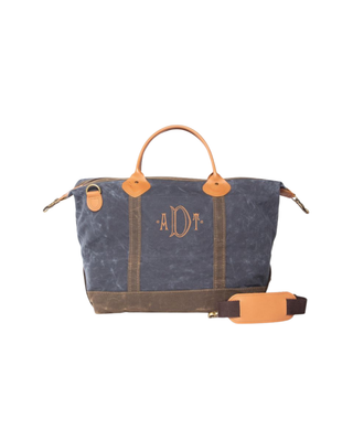 Waxed Weekender in Navy featuring premium waxed canvas, genuine leather handles, removable shoulder strap, and a spacious zip-top travel compartment.