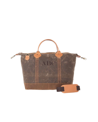Waxed Weekender in Olive featuring premium waxed canvas, genuine leather handles, removable shoulder strap, and a spacious zip-top travel compartment.