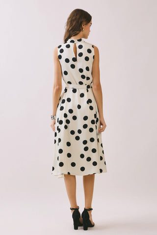 Woman wearing a polka dot dress showing back of the dress